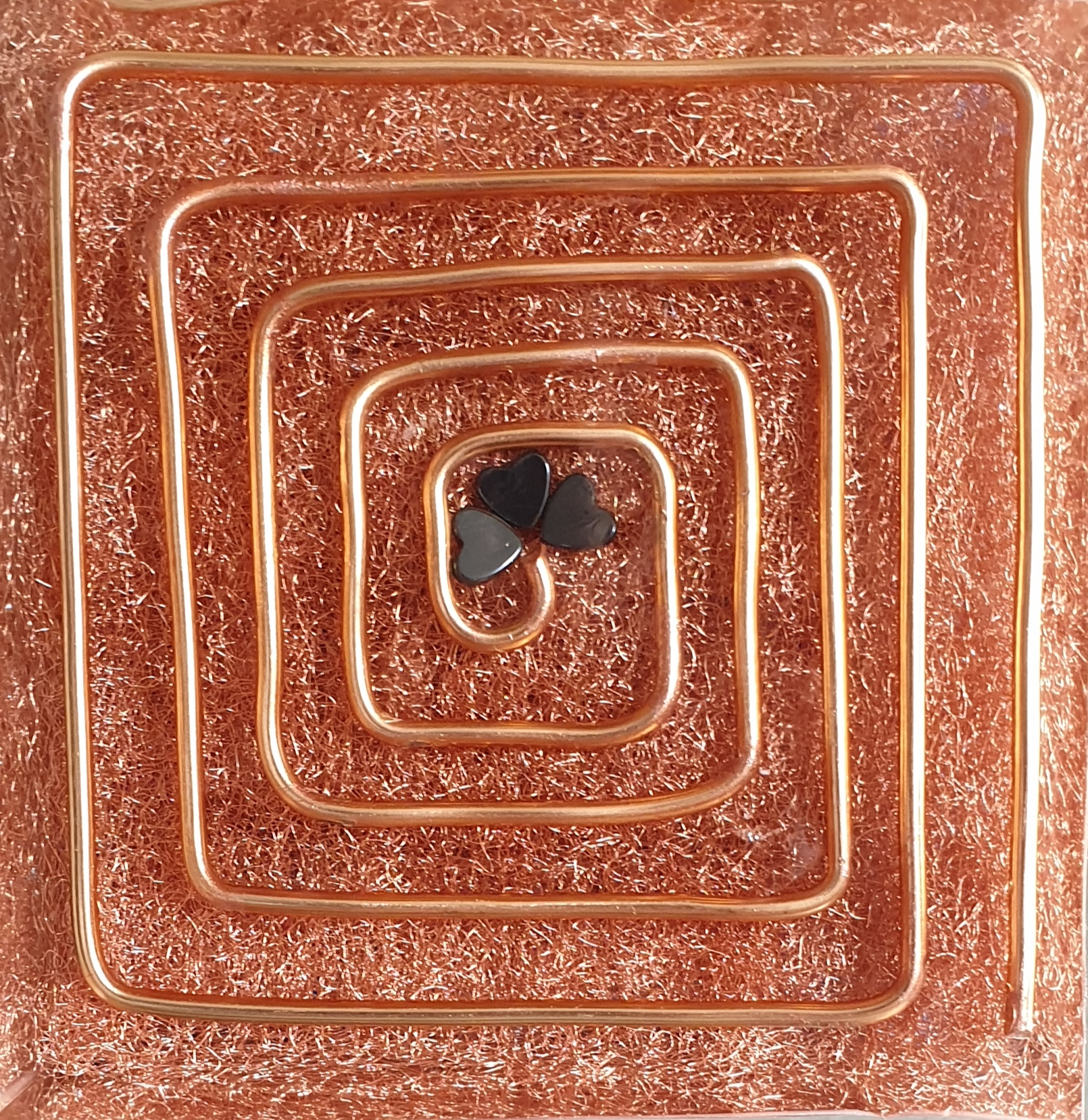 Close-up of copper spiral coil embedded in resin base