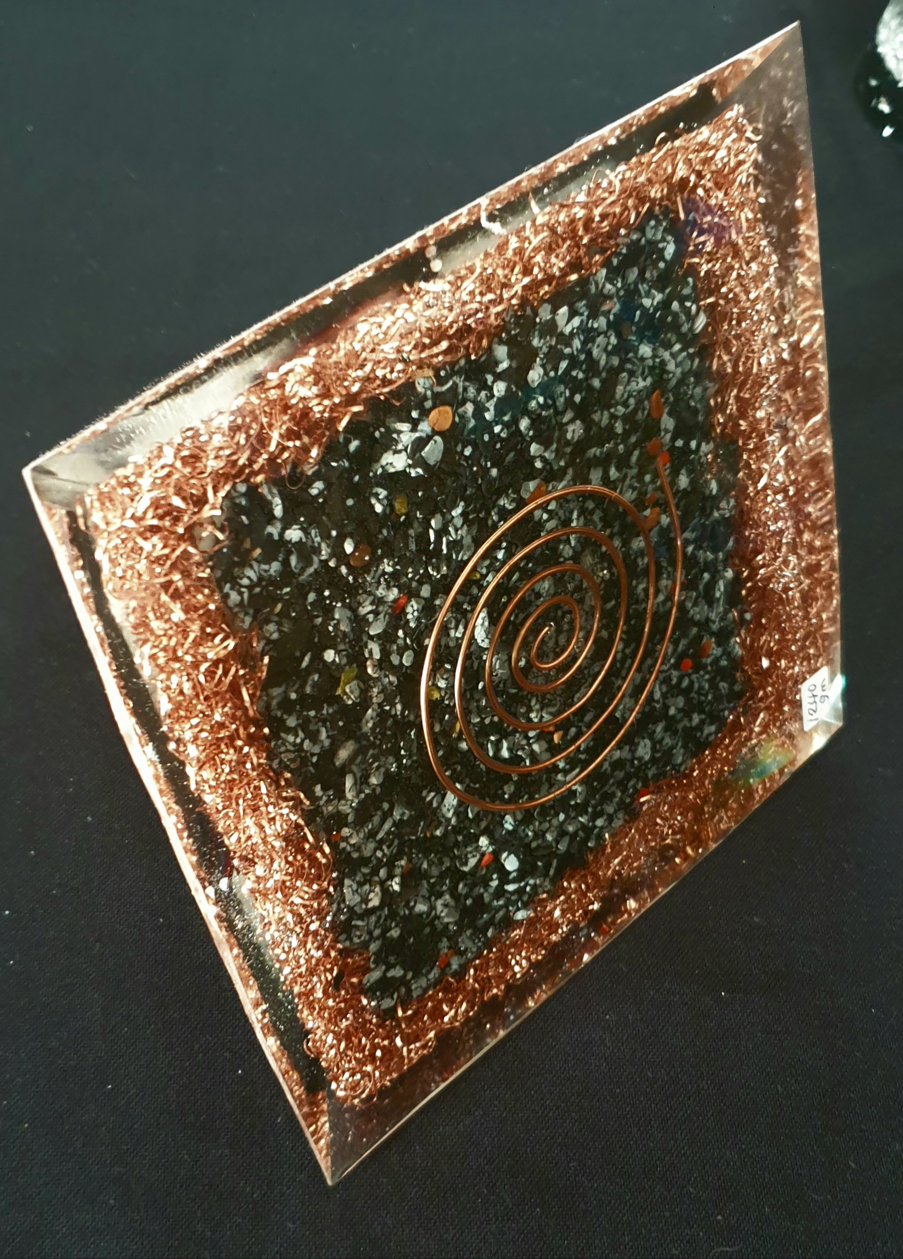 Copper spiral tile with embedded mineral fragments